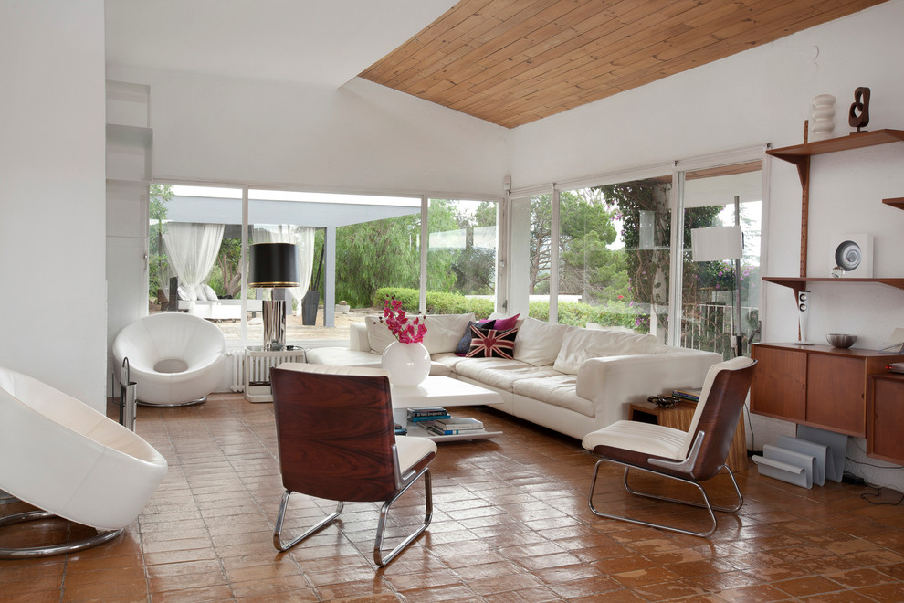 Design ideas for a large midcentury formal enclosed living room in Barcelona with white walls, terracotta flooring, no fireplace and no tv.