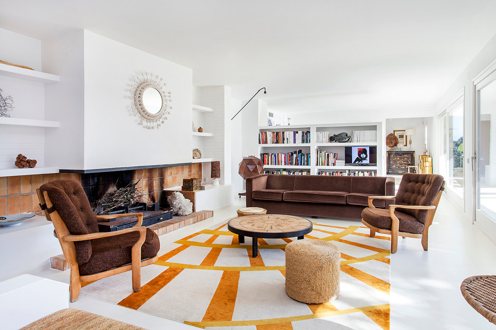 Photo of a large contemporary open plan living room in Barcelona with a reading nook, white walls, a standard fireplace and no tv.