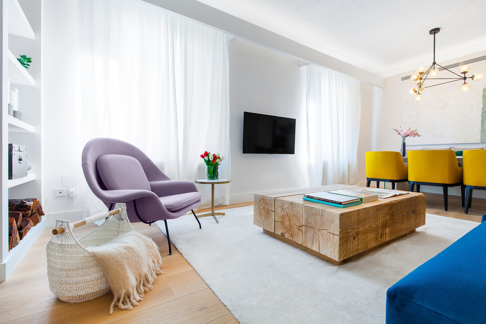 Example of a large trendy formal and open concept light wood floor living room design in Madrid with white walls, a wall-mounted tv and no fireplace
