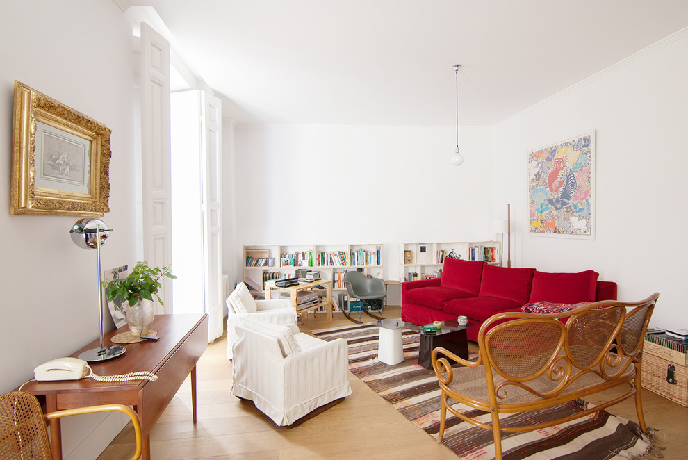 Photo of a medium sized eclectic enclosed living room in Madrid with a reading nook, white walls, light hardwood flooring, no fireplace and no tv.