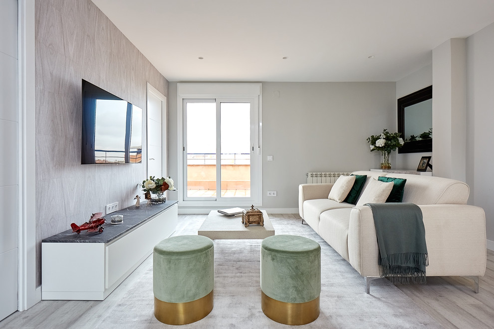 Inspiration for a contemporary light wood floor and gray floor living room remodel in Madrid with gray walls and a wall-mounted tv