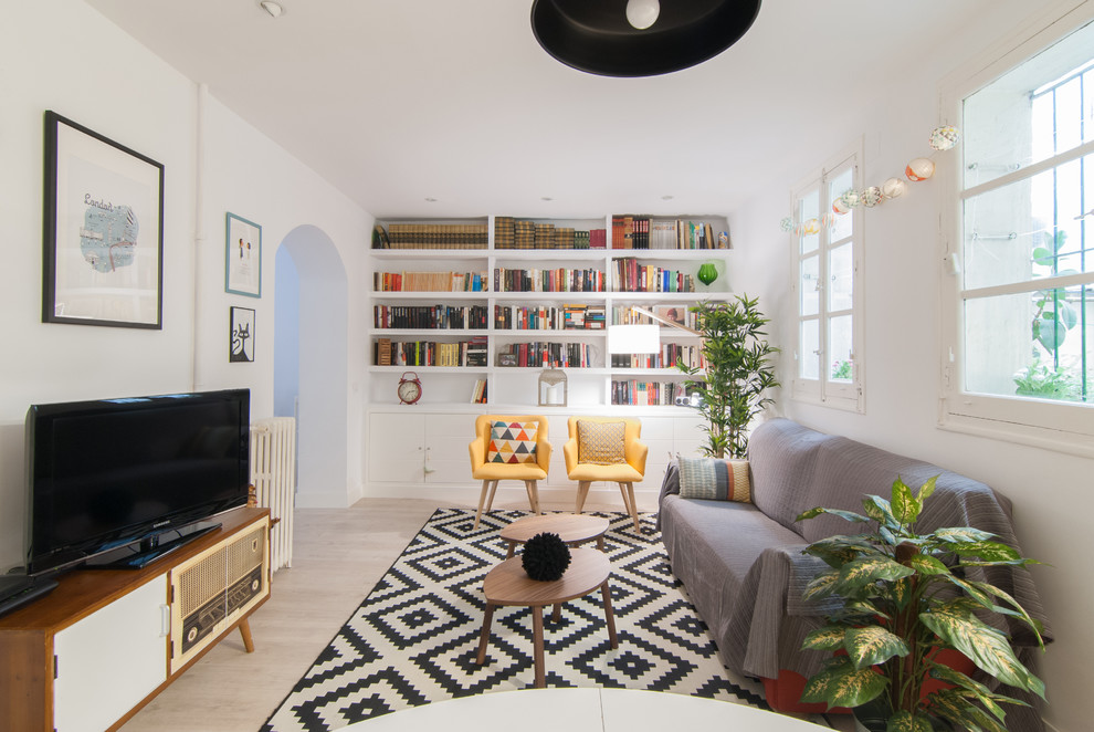 Living room library - mid-sized scandinavian open concept light wood floor and beige floor living room library idea in Madrid with white walls, no fireplace and a media wall