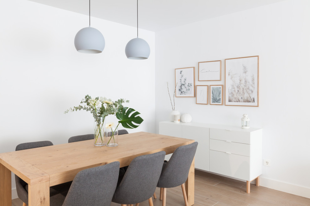 Inspiration for a large scandinavian dining room in Madrid with white walls, ceramic flooring, no fireplace and brown floors.