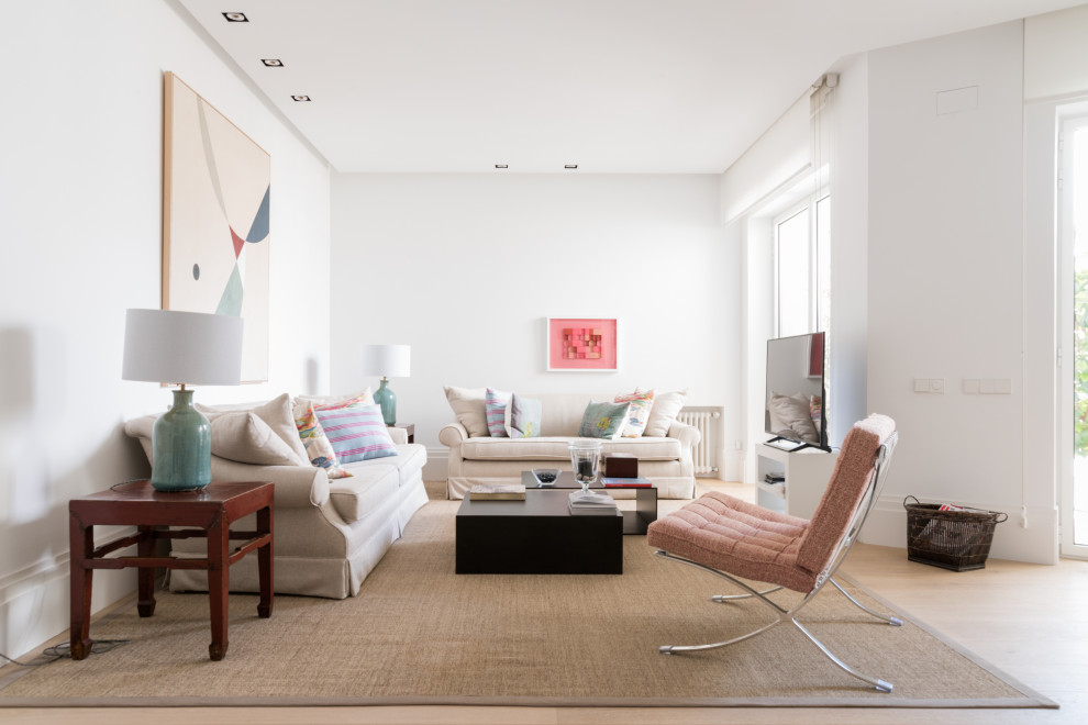 Immagine di un soggiorno chic stile loft con pareti bianche, parquet chiaro e pavimento beige