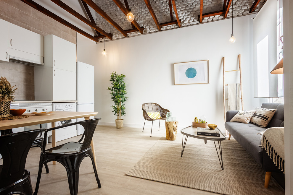 Example of a mid-sized danish formal and open concept light wood floor living room design in Madrid with white walls and no fireplace