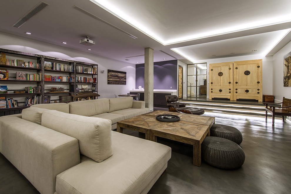 Large contemporary open plan living room in Madrid with a reading nook, multi-coloured walls, no fireplace and a built-in media unit.