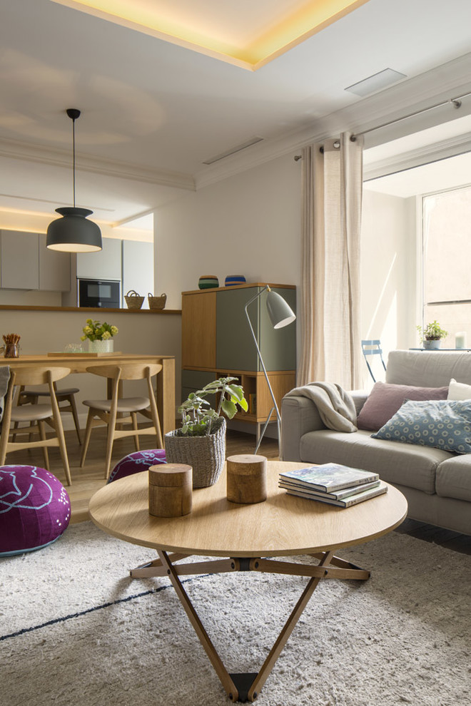 Photo of a large scandi enclosed living room in Other with white walls, medium hardwood flooring, no fireplace and a wall mounted tv.