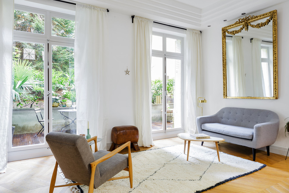 Стильный дизайн: изолированная, парадная гостиная комната среднего размера в современном стиле с белыми стенами и светлым паркетным полом без камина, телевизора - последний тренд