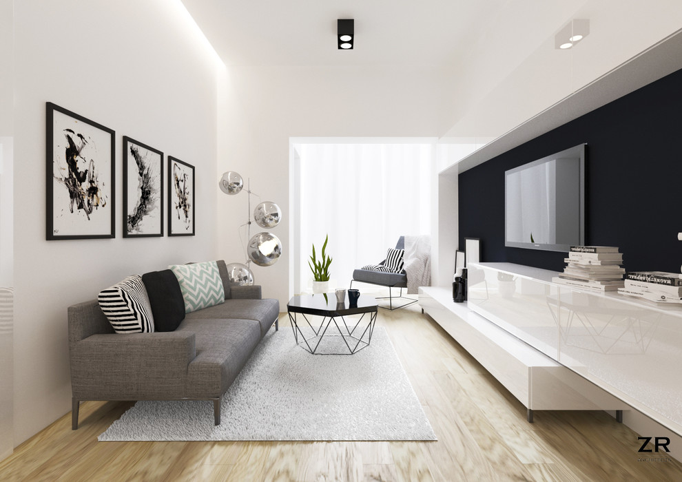 Example of a small minimalist open concept light wood floor living room design in Brussels with white walls, no fireplace and a wall-mounted tv