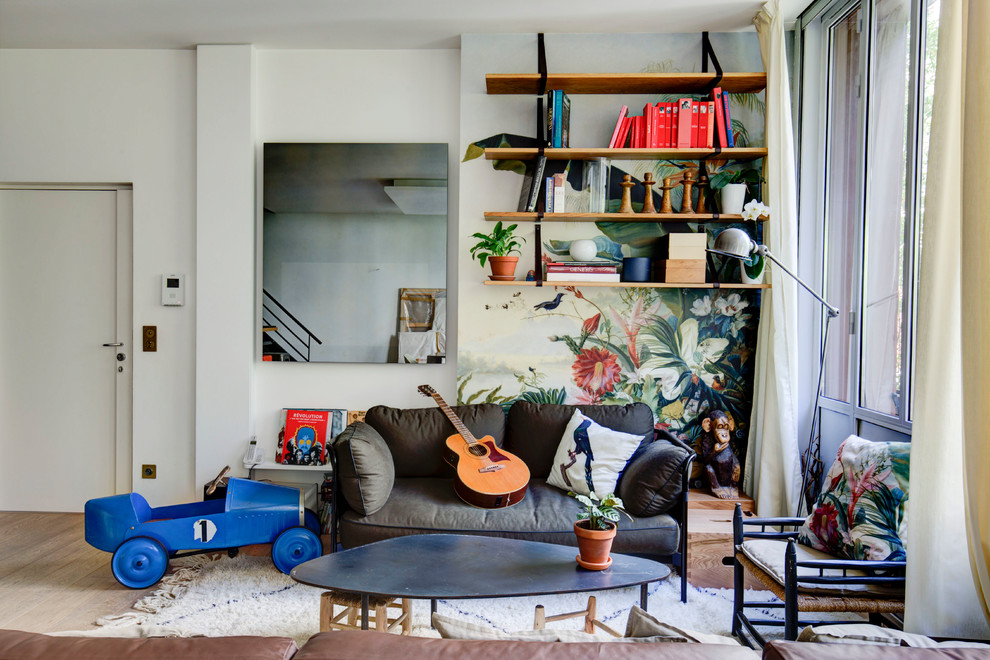 Foto di un soggiorno design di medie dimensioni e aperto con libreria, pareti bianche, nessun camino, TV nascosta, parquet chiaro e pavimento beige
