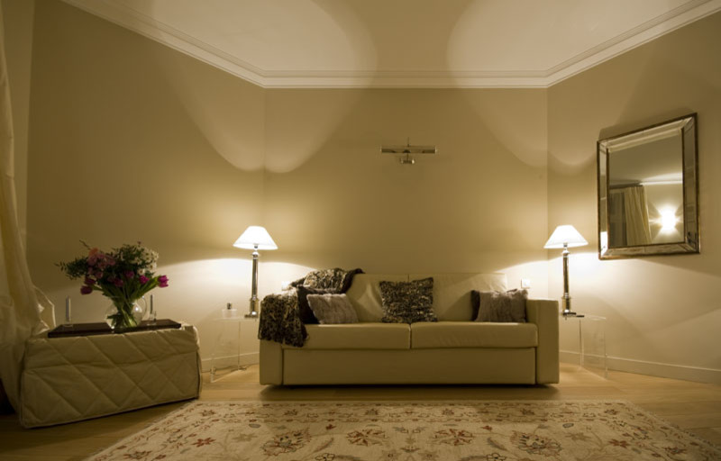 This is an example of a large traditional open plan living room in Paris with brown walls, light hardwood flooring, no fireplace, a wall mounted tv and brown floors.