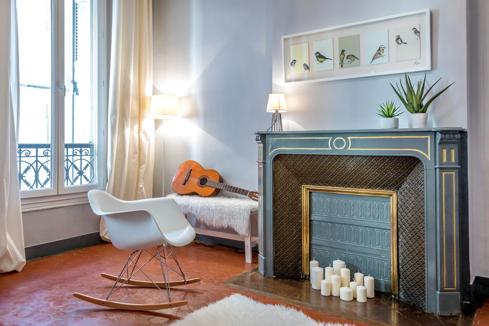 Living room - mid-sized transitional enclosed terra-cotta tile living room idea in Marseille with gray walls, a standard fireplace, a stone fireplace, no tv and a music area