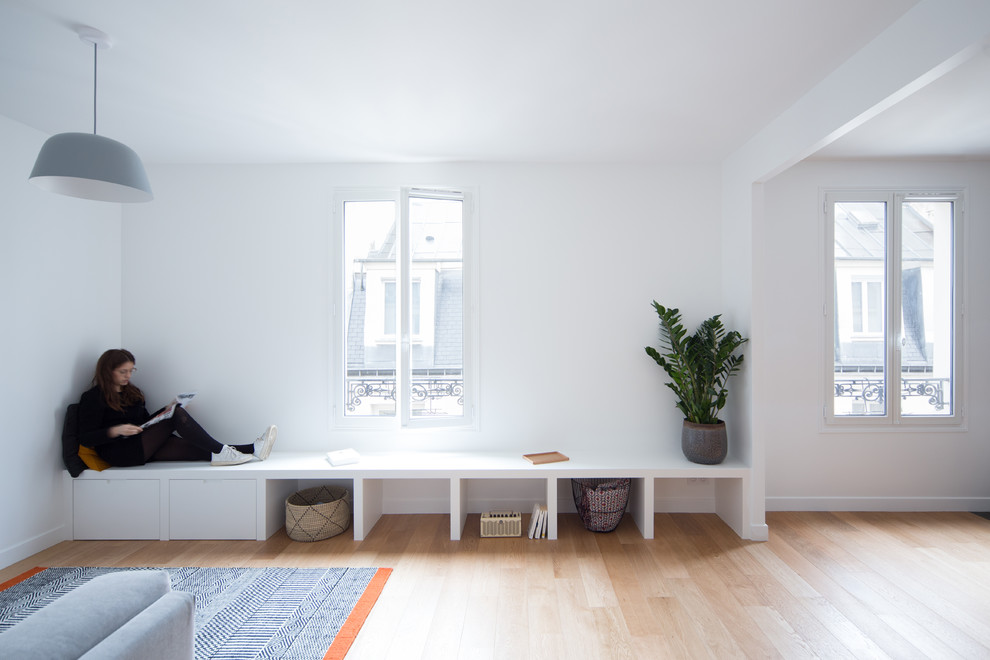 Design ideas for a medium sized scandi formal enclosed living room in Paris with white walls, light hardwood flooring, no fireplace, no tv and brown floors.