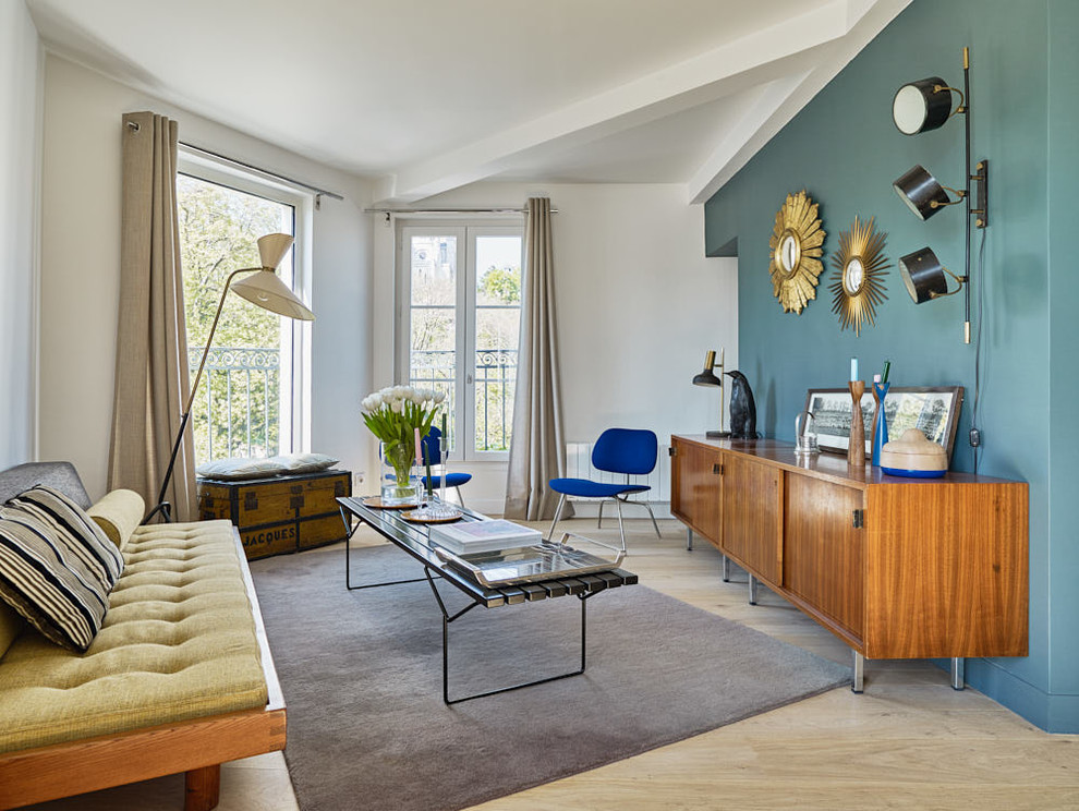 Example of a mid-century modern formal and enclosed light wood floor and beige floor living room design in Paris with multicolored walls, no fireplace and no tv