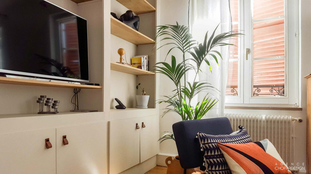 Idee per un grande soggiorno eclettico con libreria, pareti blu, parquet chiaro e TV autoportante