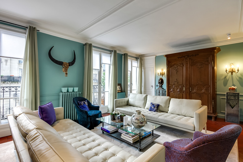 Inspiration for a large traditional enclosed living room in Paris with a reading nook, blue walls, medium hardwood flooring, no fireplace and a freestanding tv.