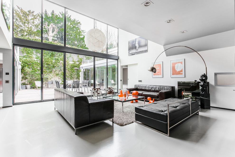 Ispirazione per un soggiorno design con pareti bianche e pavimento grigio