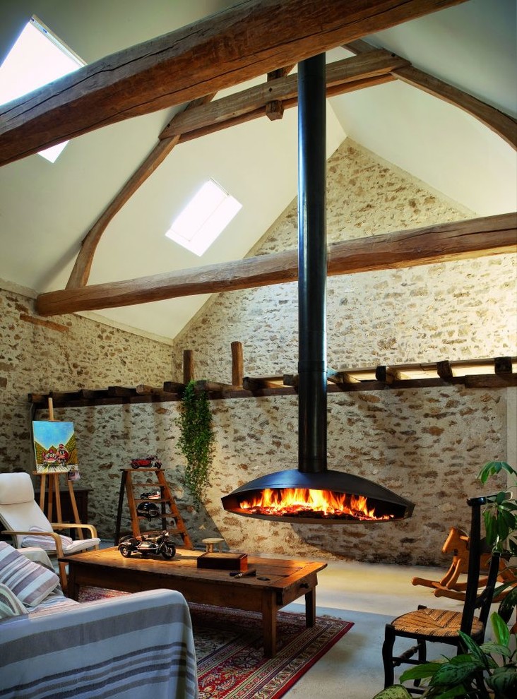Design ideas for a country living room in Montpellier with a hanging fireplace and a metal fireplace surround.