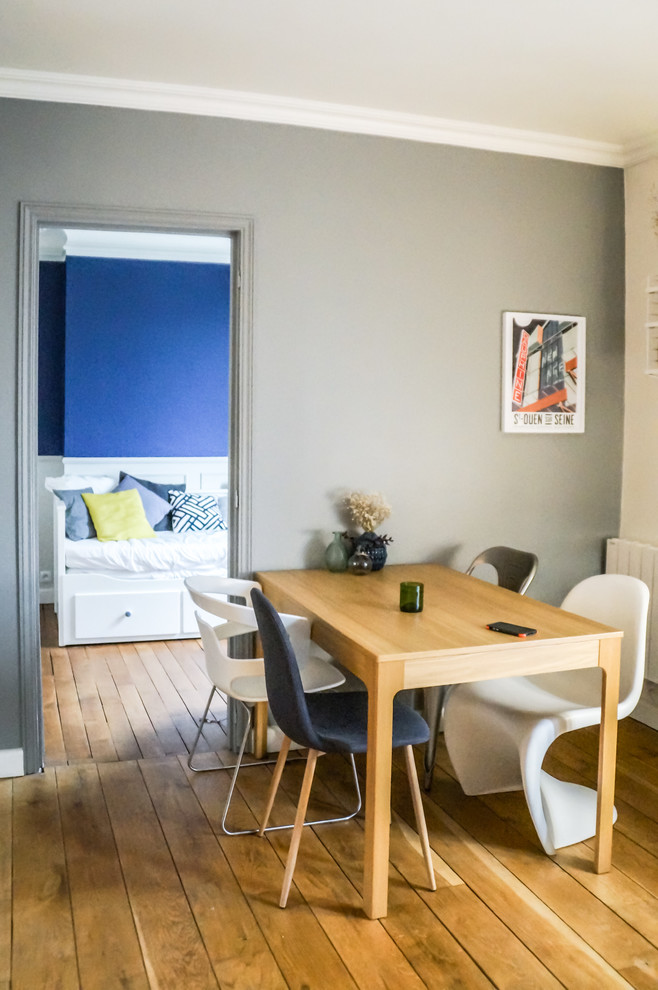 Imagen de comedor escandinavo con paredes azules y suelo de madera clara