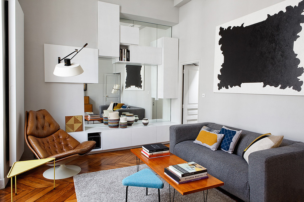 Inspiration for a contemporary enclosed medium tone wood floor living room remodel in Paris with gray walls