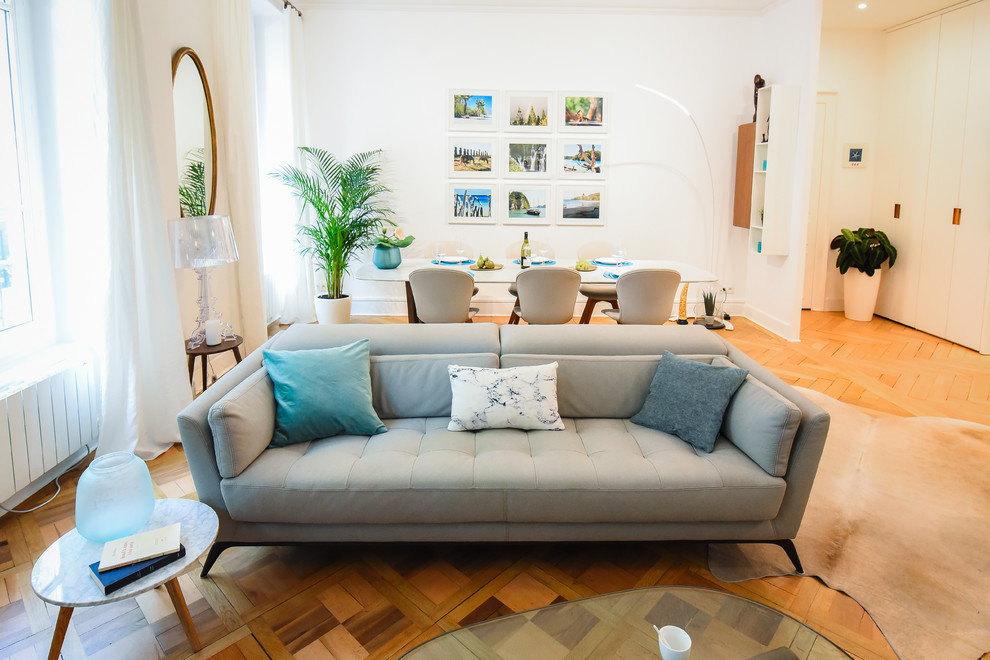 Offenes Modernes Wohnzimmer mit hellem Holzboden, weißer Wandfarbe und braunem Boden in Lyon