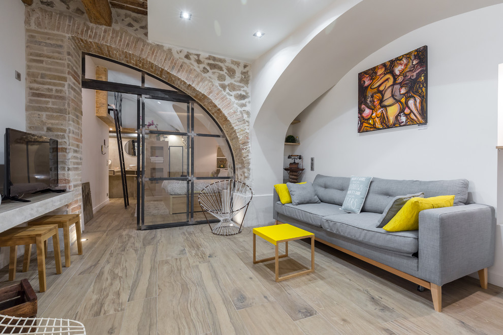 This is an example of a contemporary grey and yellow living room in Nice.