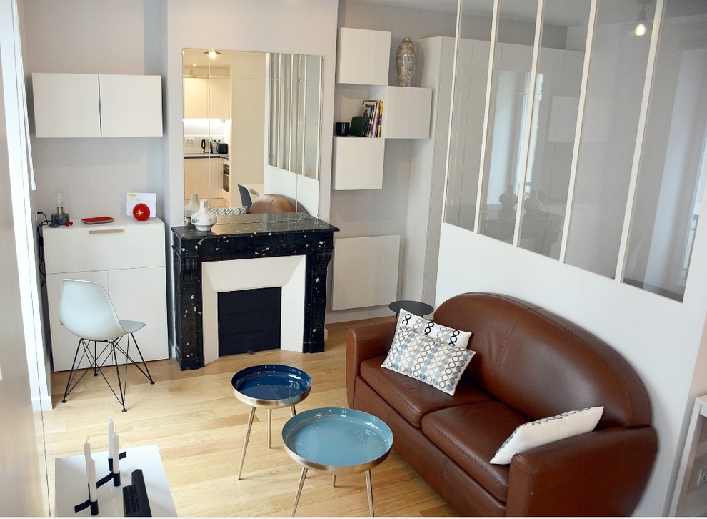 Cette photo montre un salon tendance de taille moyenne et ouvert avec un mur gris et une cheminée standard.