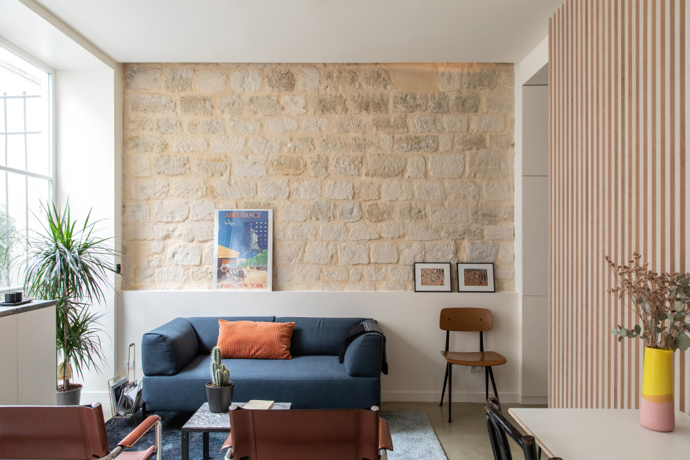 Aménagement d'un petit salon éclectique ouvert avec un mur blanc, sol en béton ciré, aucune cheminée, aucun téléviseur et un sol gris.