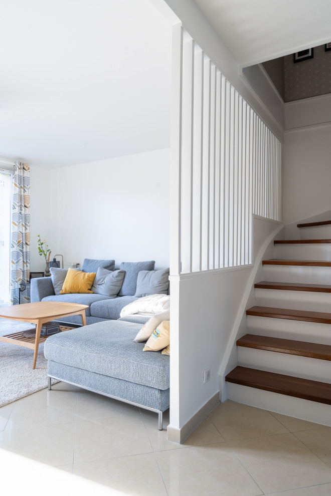Immagine di un soggiorno design aperto con libreria, pareti bianche e TV autoportante