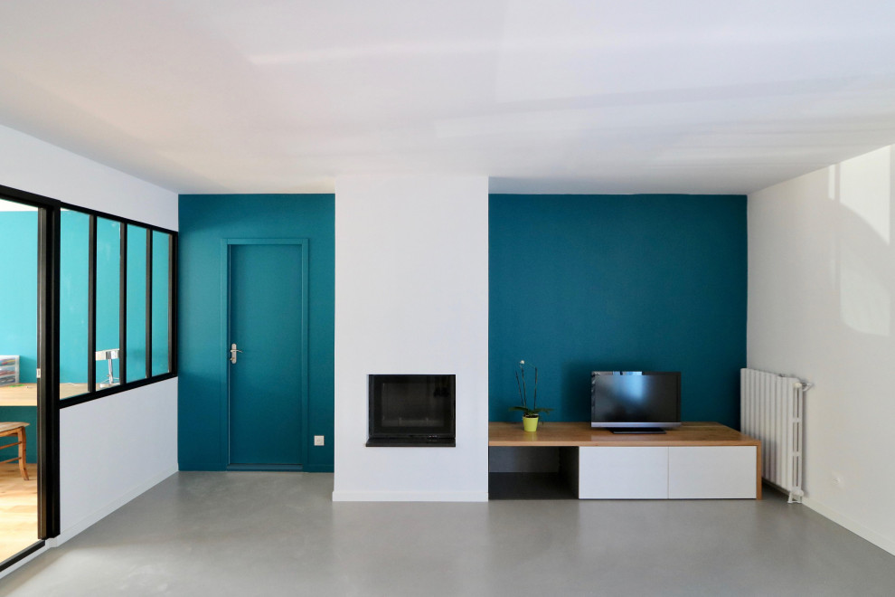 Idéer för att renovera ett stort funkis allrum med öppen planlösning, med blå väggar, betonggolv, en standard öppen spis och grått golv