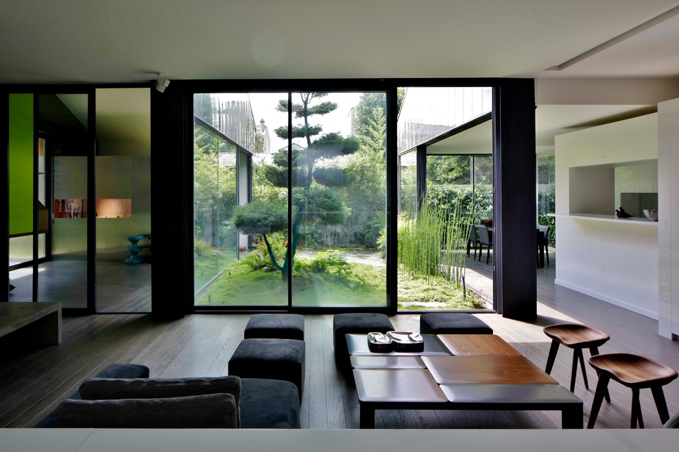 Large modern formal open plan living room in Paris with white walls, no fireplace and no tv.