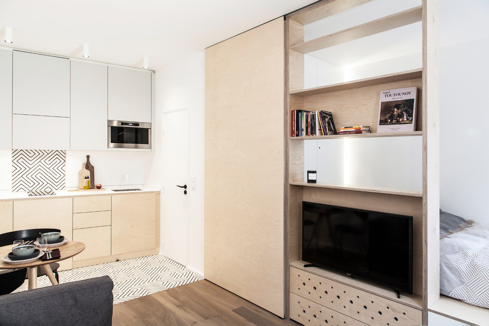 Photo of a medium sized scandinavian open plan living room in Paris with a reading nook, white walls, medium hardwood flooring, no fireplace, a built-in media unit, brown floors and wood walls.