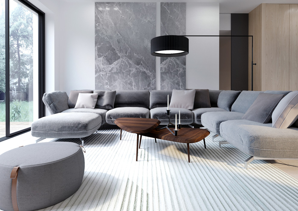 Esempio di un grande soggiorno moderno aperto con pareti grigie, parquet chiaro e TV a parete