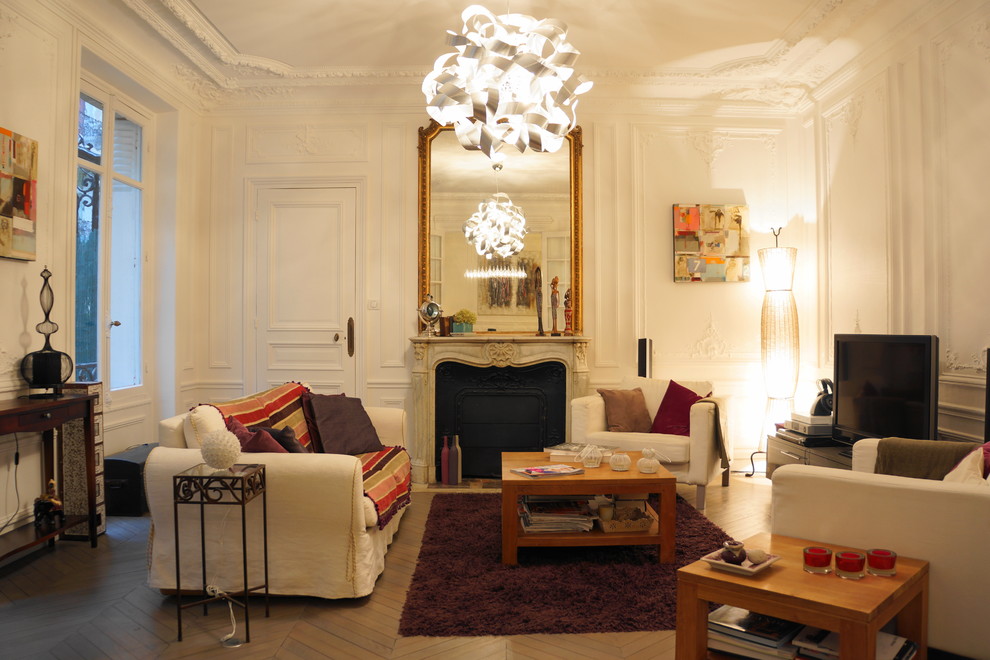 На фото: изолированная гостиная комната среднего размера в классическом стиле с белыми стенами, стандартным камином, фасадом камина из камня, отдельно стоящим телевизором и деревянным полом