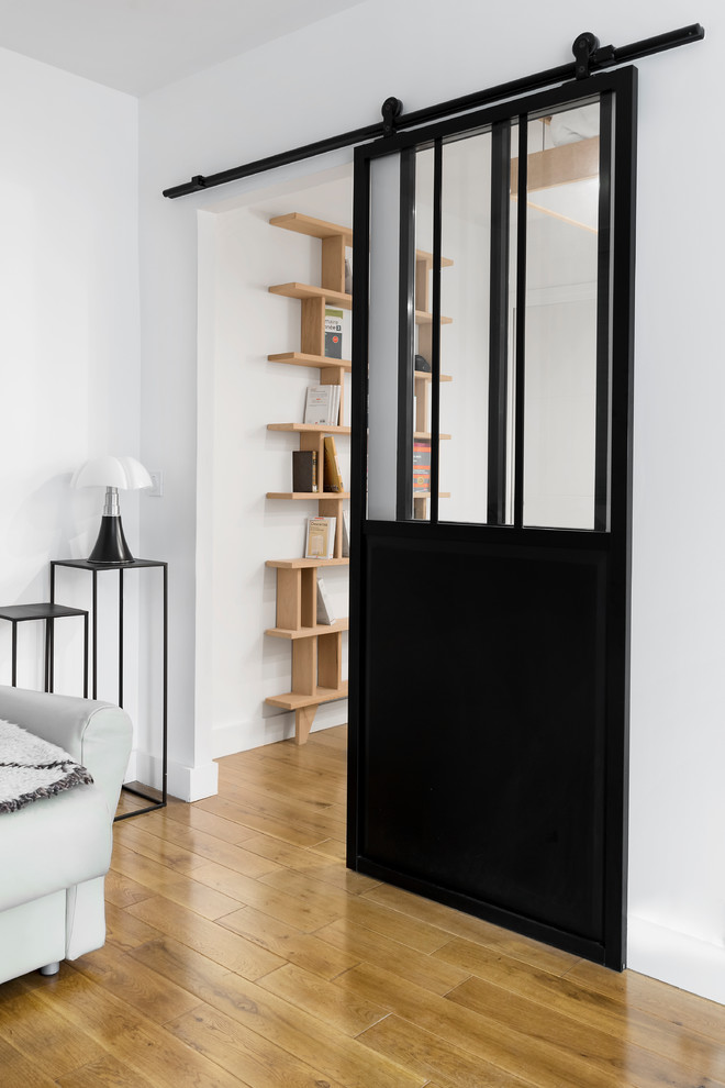 Medium sized scandinavian formal open plan living room in Paris with white walls, medium hardwood flooring and no fireplace.