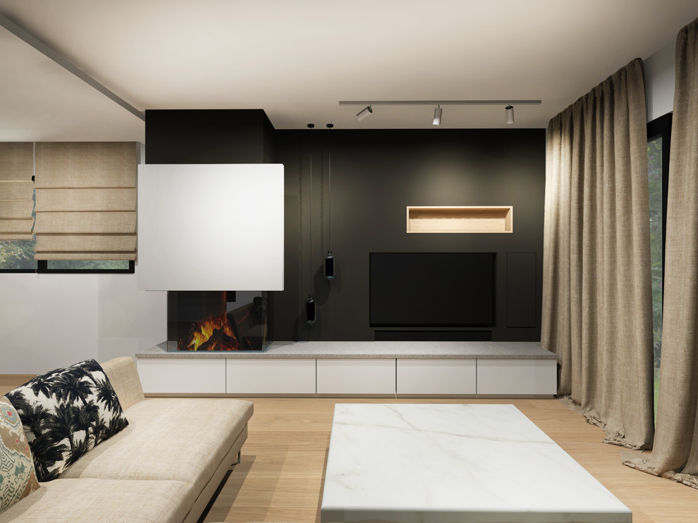 Источник вдохновения для домашнего уюта: открытая гостиная комната в современном стиле с черными стенами, светлым паркетным полом, двусторонним камином и мультимедийным центром