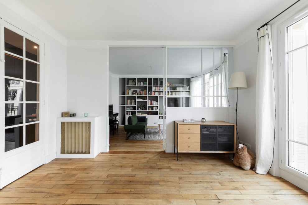 Design ideas for a medium sized scandi enclosed living room in Paris with a reading nook, white walls, light hardwood flooring, no fireplace, a built-in media unit and beige floors.
