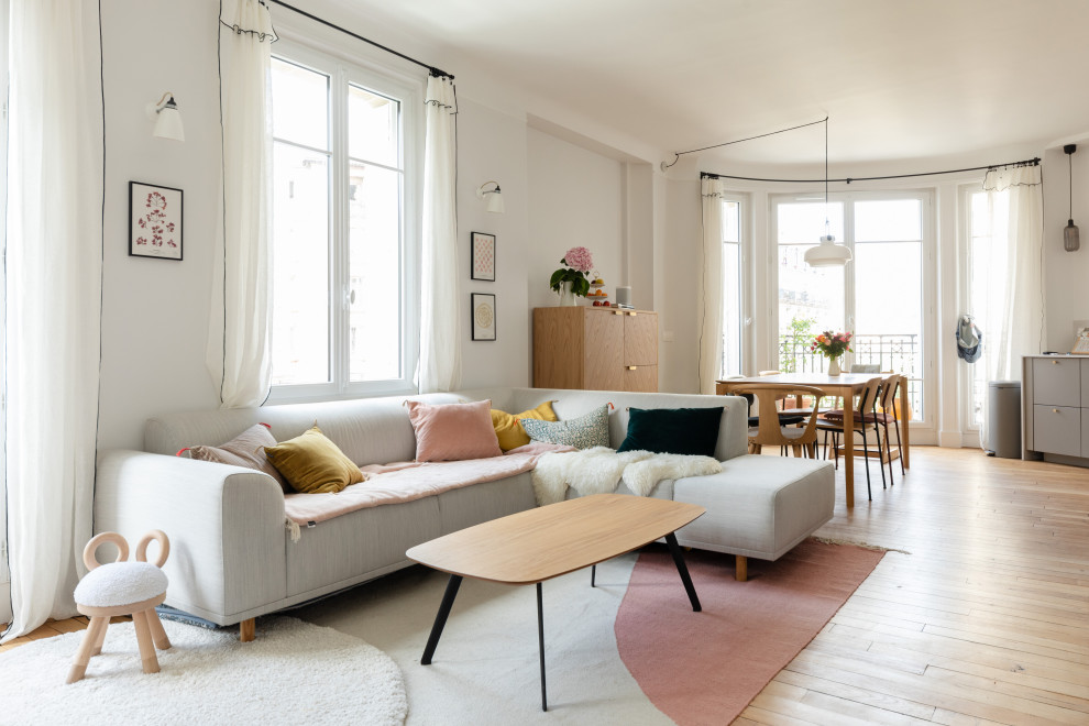 Medium sized scandinavian open plan living room in Paris with white walls, light hardwood flooring, no fireplace, no tv and beige floors.