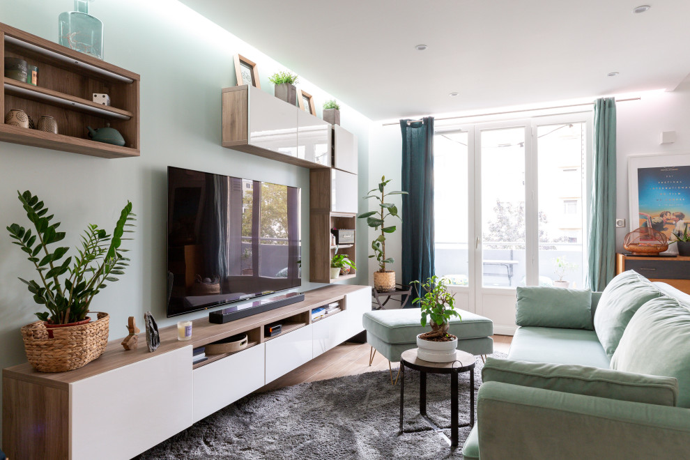 Small contemporary open plan living room in Lyon with green walls, ceramic flooring, no fireplace, a wall mounted tv and brown floors.