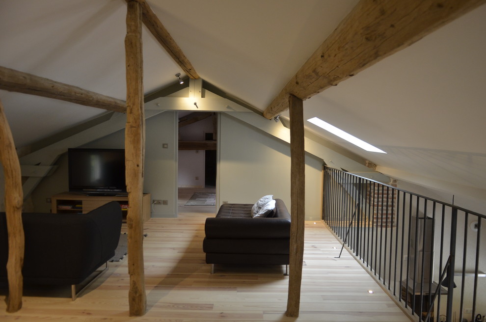 Inspiration for a medium sized farmhouse open plan living room in Lyon with a reading nook, beige walls, light hardwood flooring and beige floors.