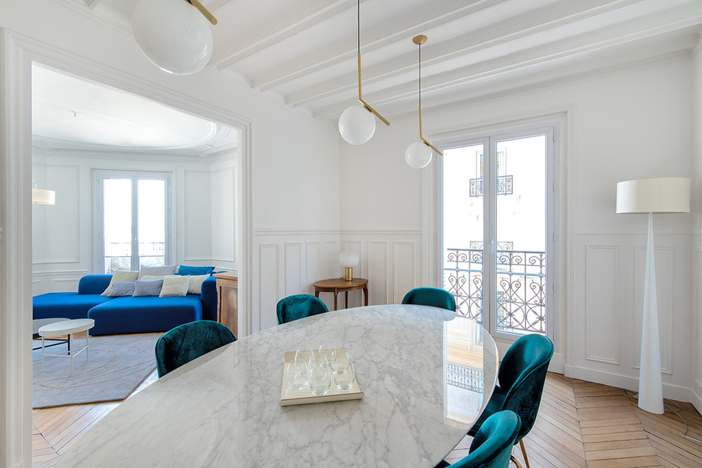 Inspiration for a mid-sized transitional open concept medium tone wood floor and brown floor living room library remodel in Paris with white walls, a standard fireplace, a stone fireplace and a concealed tv