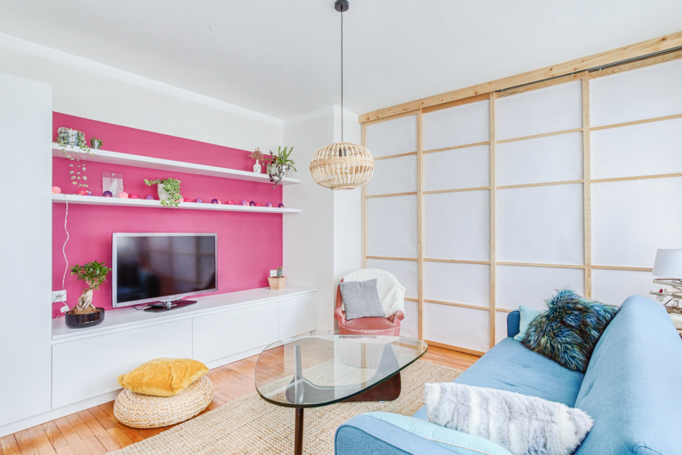 Réalisation d'un salon design de taille moyenne et ouvert avec un mur rose, parquet clair, aucune cheminée et un téléviseur fixé au mur.
