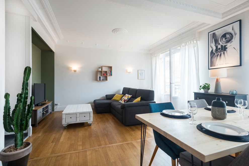 Idée de décoration pour un salon nordique de taille moyenne et ouvert avec un mur vert, parquet clair et un téléviseur indépendant.