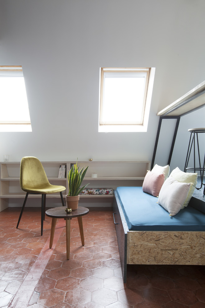 Example of a mid-sized trendy open concept terra-cotta tile and brown floor living room design in Paris with white walls and no fireplace