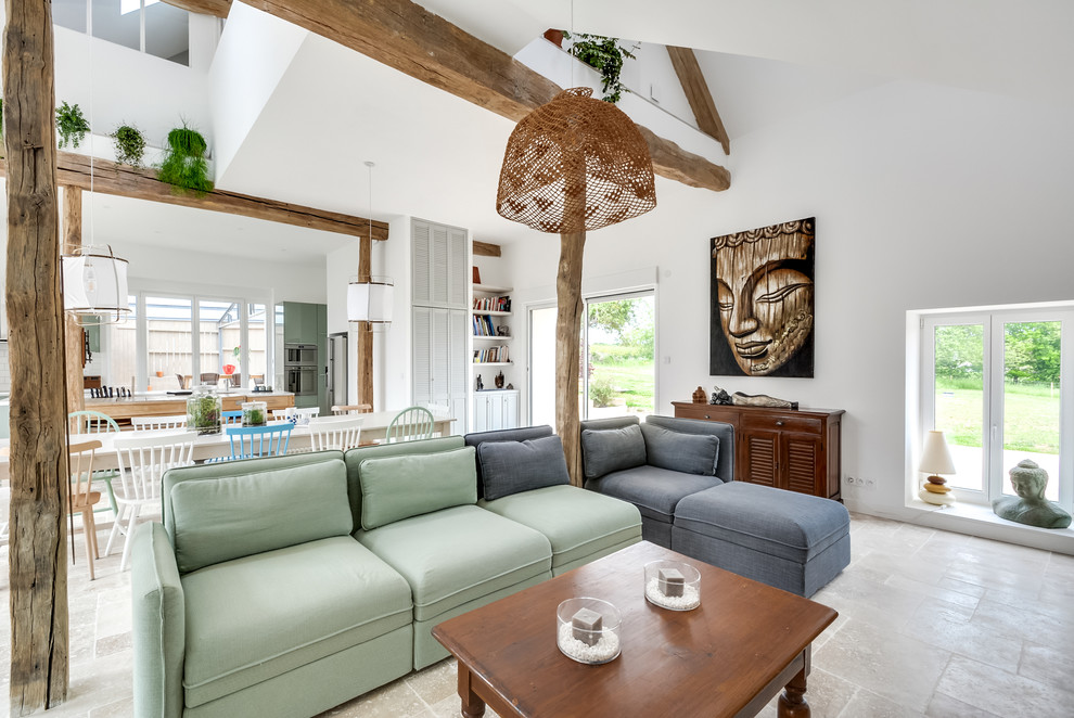 Example of a large eclectic formal and open concept marble floor and beige floor living room design in Paris with white walls, a wood stove and a tv stand