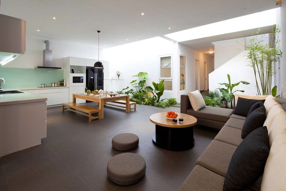 This is an example of a large contemporary formal open plan living room in Paris with white walls, ceramic flooring, no fireplace and no tv.