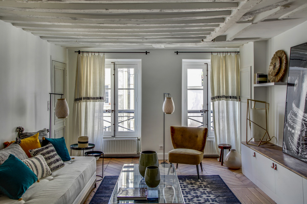 Kleines, Fernseherloses, Abgetrenntes Maritimes Wohnzimmer ohne Kamin mit weißer Wandfarbe, braunem Holzboden und braunem Boden in Paris