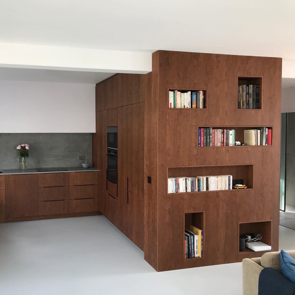 This is an example of a contemporary open plan living room in Paris with a reading nook, brown walls, no fireplace, no tv, grey floors and wood walls.
