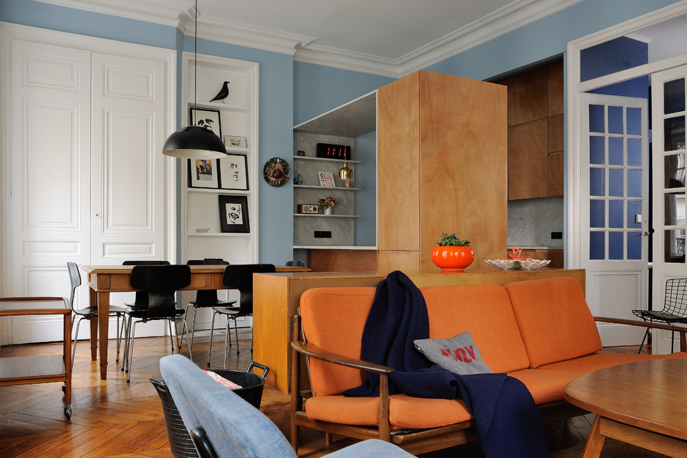 Foto de salón con barra de bar cerrado bohemio de tamaño medio con paredes azules y suelo de madera oscura