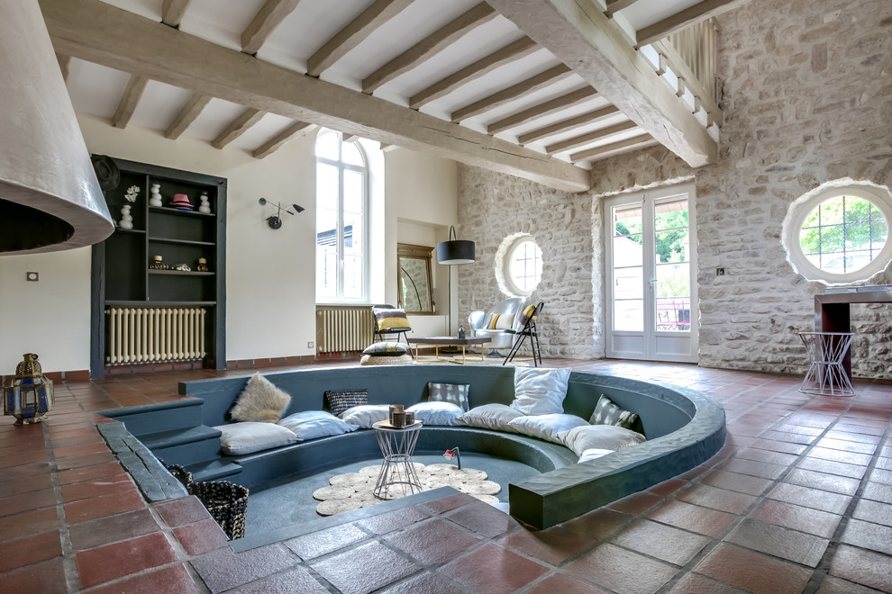 Medium sized mediterranean open plan living room in Paris with terracotta flooring, beige walls and red floors.
